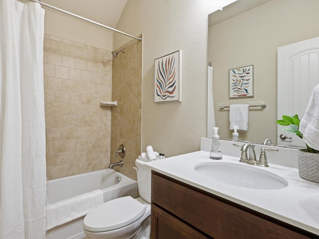 609 Racine Drive Oak Point, TX 75068 - Photo 21 of 30 a bathroom with a sink a toilet and shower