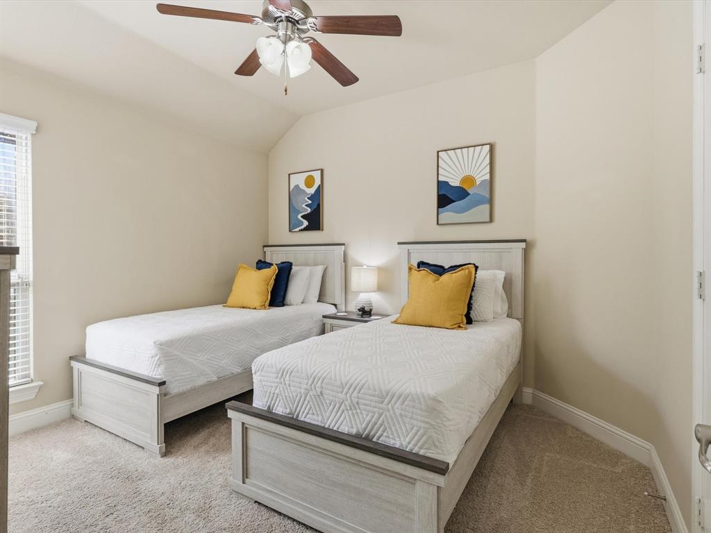 609 Racine Drive Oak Point, TX 75068 - Photo 22 of 30 a bedroom with two beds and painting on the wall