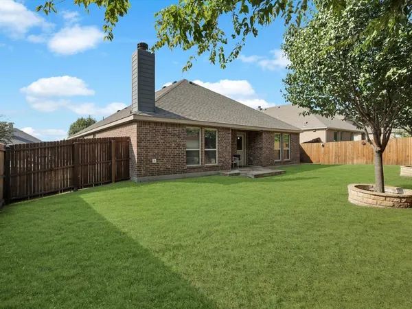 a front view of a house with a garden and yard