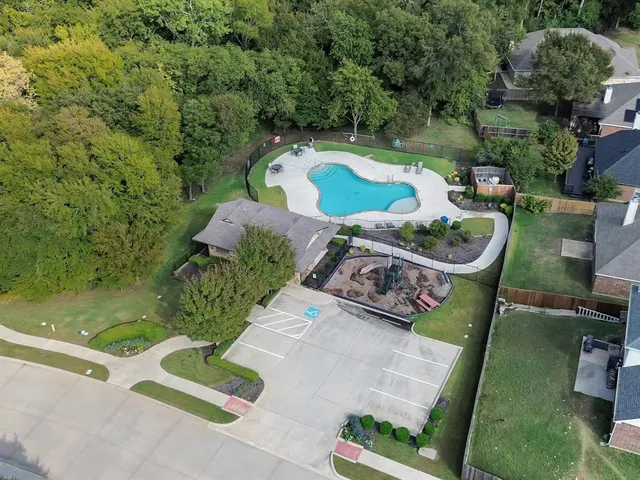 an aerial view of a house with swimming pool and garden
