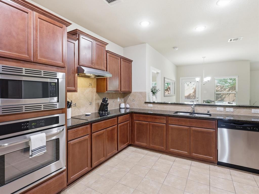 609 Racine Drive Oak Point, TX 75068 - Photo 6 of 30 a kitchen with sink and cabinets