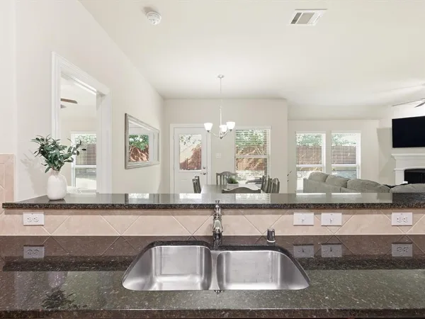a kitchen with granite countertop a sink and a counter top space