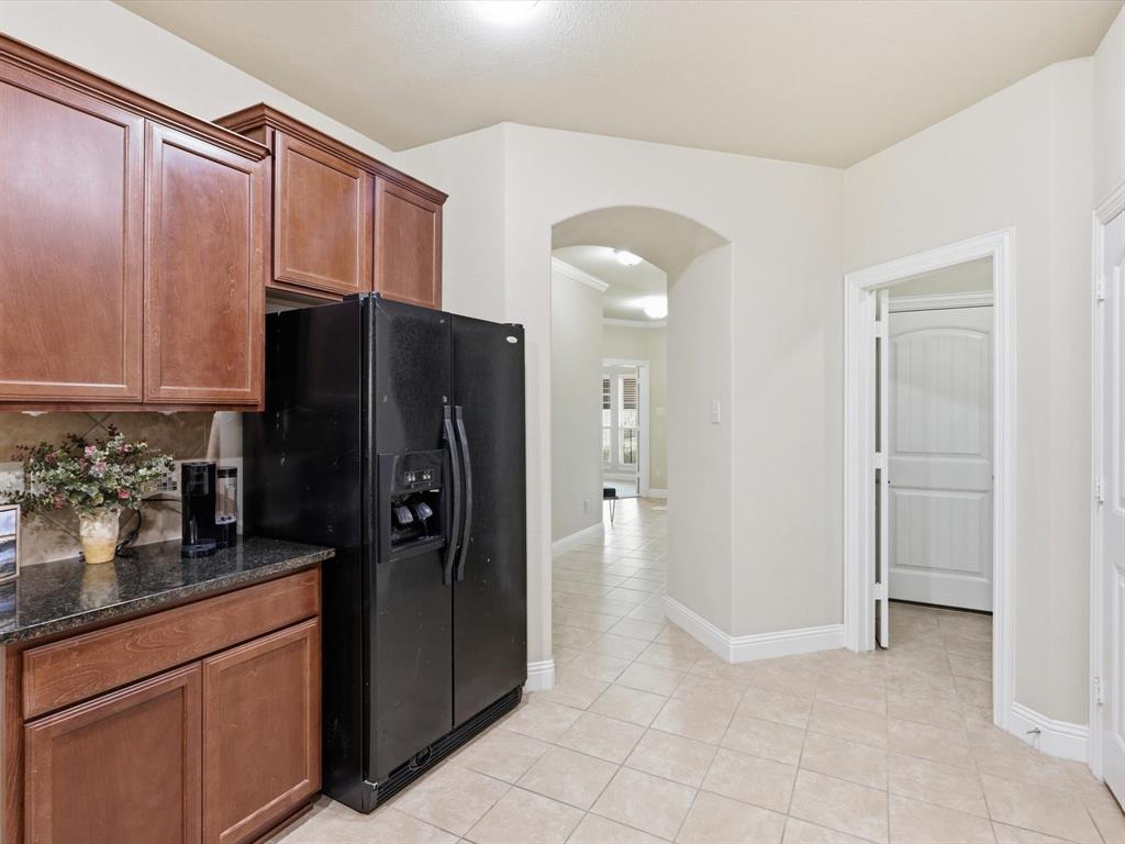609 Racine Drive Oak Point, TX 75068 - Photo 9 of 30 a kitchen with stainless steel appliances granite countertop a refrigerator and a sink
