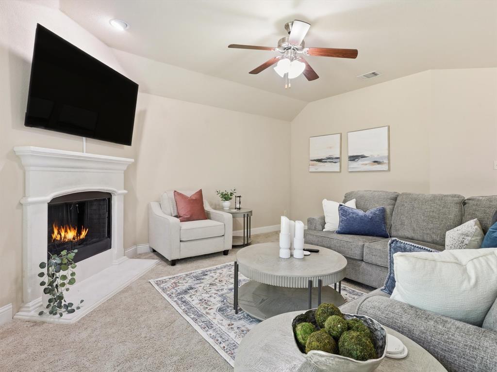 609 Racine Drive Oak Point, TX 75068 - Photo 10 of 30 a living room with furniture a fireplace and a flat screen tv