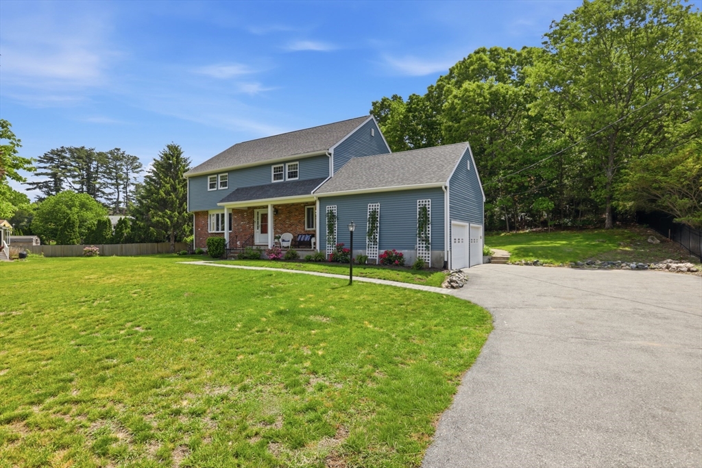 94 Johnson Road Winchester, MA 01890 - Photo 2 of 40 a view of house in front of a big yard with large trees