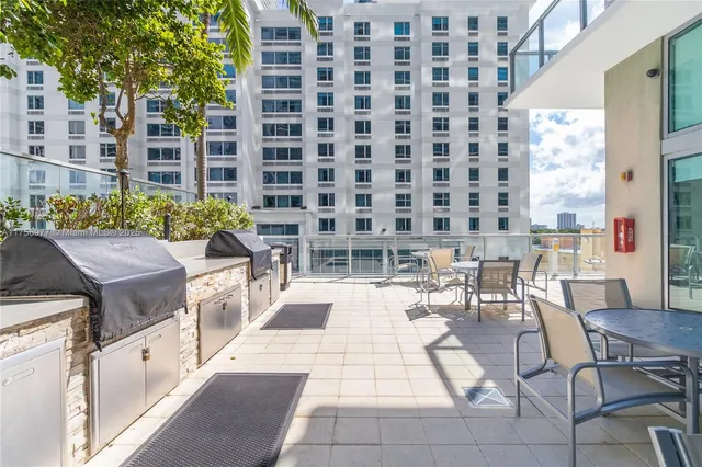 a view of a patio with dining table and chairs
