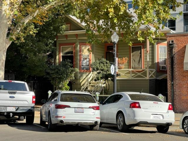 a view of cars parked in front of a house