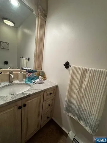 a bathroom with a granite countertop sink and a mirror