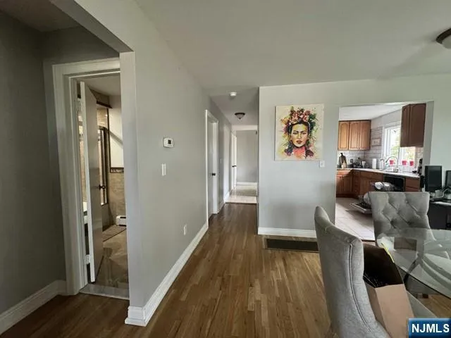 a view of a living room with furniture and wooden floor