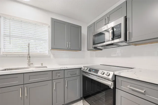 a kitchen with a sink and cabinets