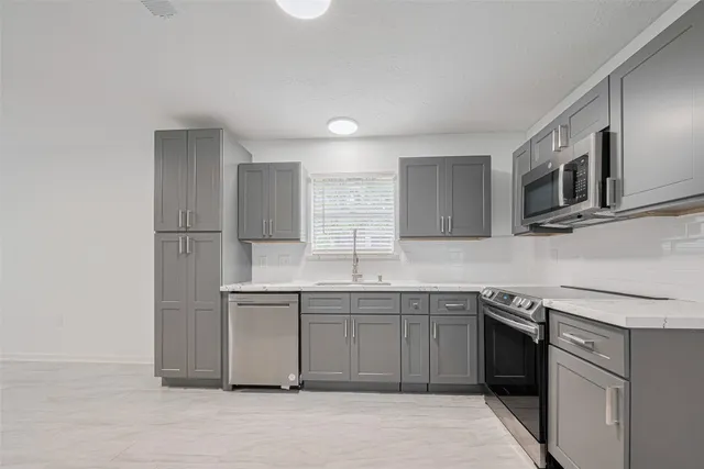 a kitchen with a sink and cabinets