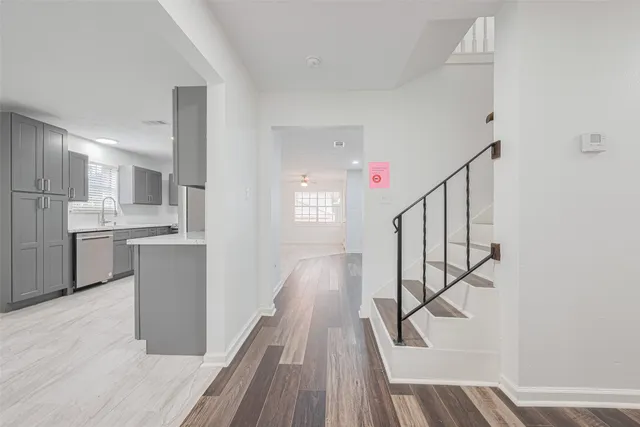a view of a kitchen with wooden floor and electronic appliances