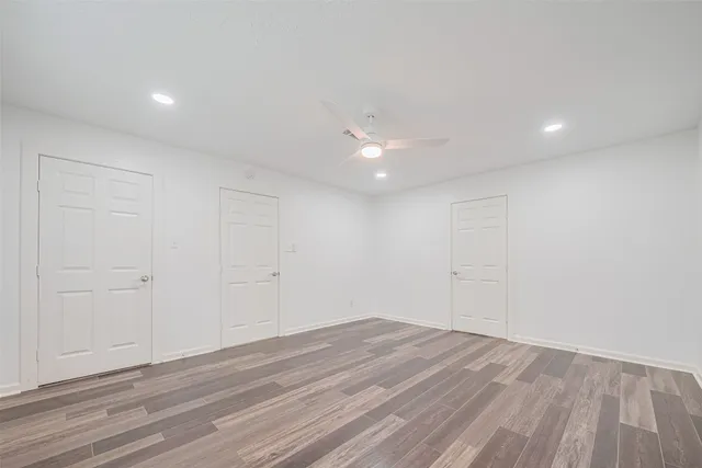 a view of a room with wooden floor and white walls