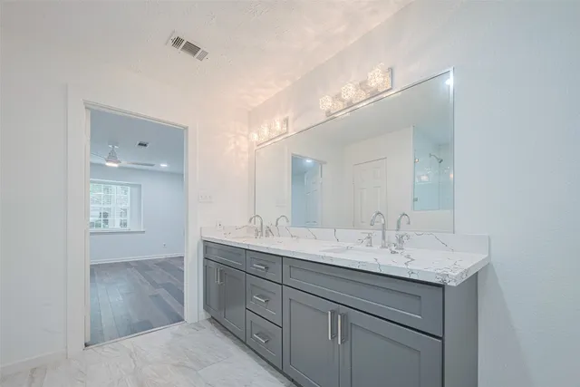 a bathroom with a sink double vanity and a mirror