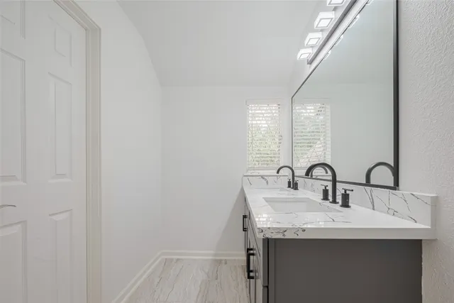 a bathroom with a sink and a mirror