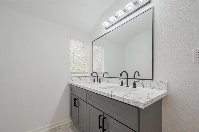a bathroom with a sink and a mirror