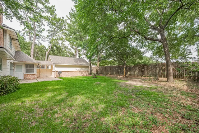 a view of backyard with house and green space