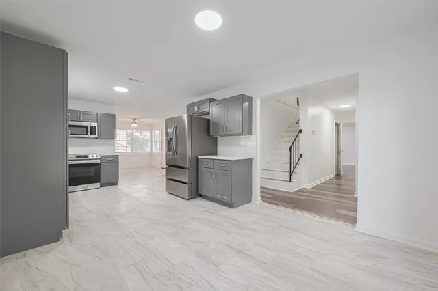 a kitchen with a refrigerator and a sink
