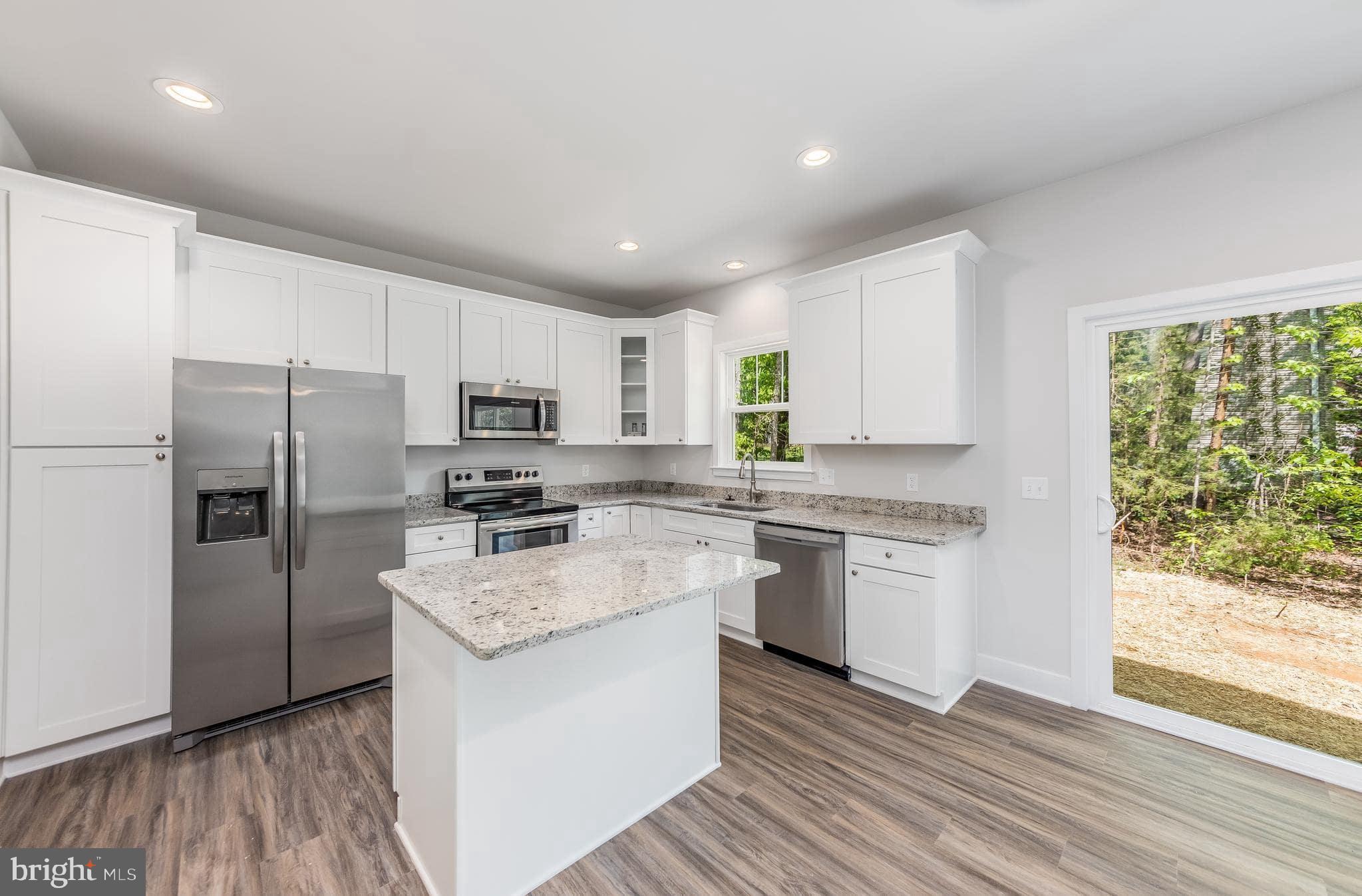 200 Victoria Drive Ruther Glen, VA 22546 - Photo 20 of 45 a kitchen with a refrigerator stove and microwave