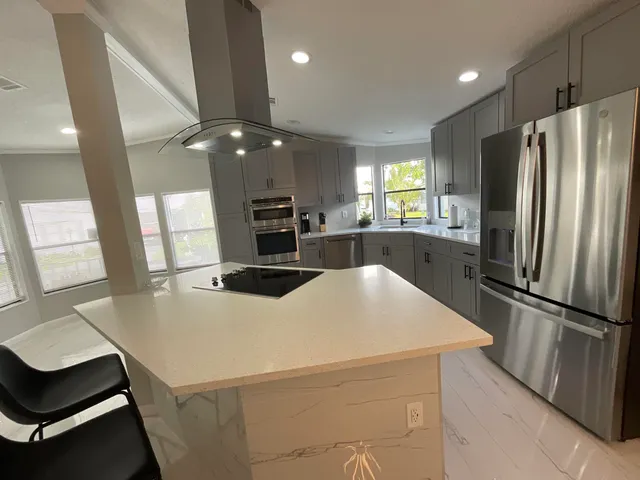 a kitchen with stainless steel appliances a refrigerator and a stove top oven