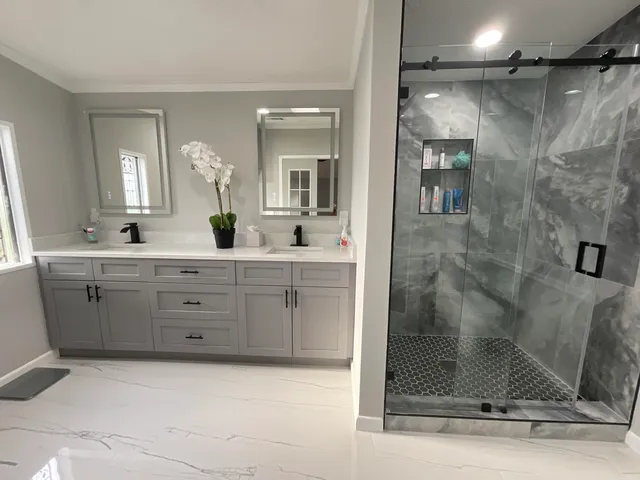 a bathroom with a shower sink and mirror