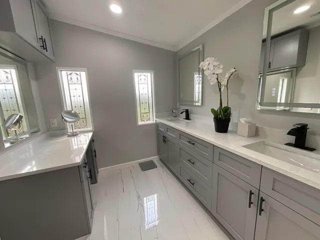a spacious bathroom with double sink and a mirror