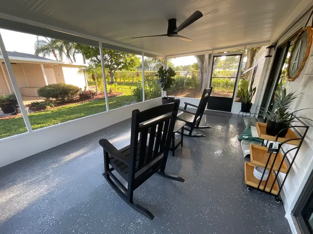 a view of a livingroom with furniture and a large window