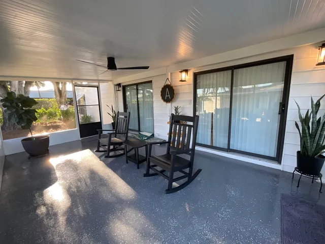 a view of a house with backyard and porch