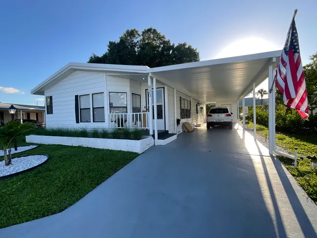 a view of a porch with furniture and a yard