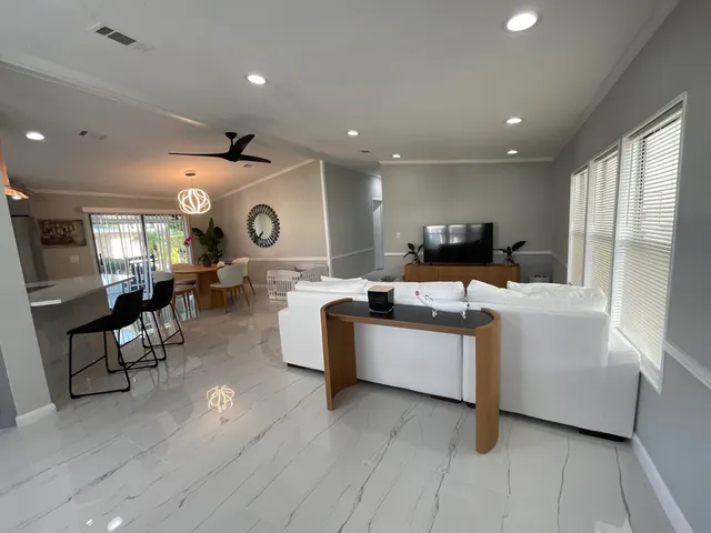 a room with lots of furniture and view of living room