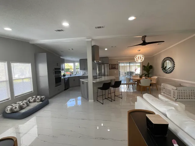 a kitchen with cabinets and chairs
