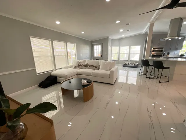 a living room with furniture and a large window