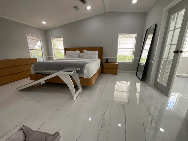 a bedroom with a bed and window