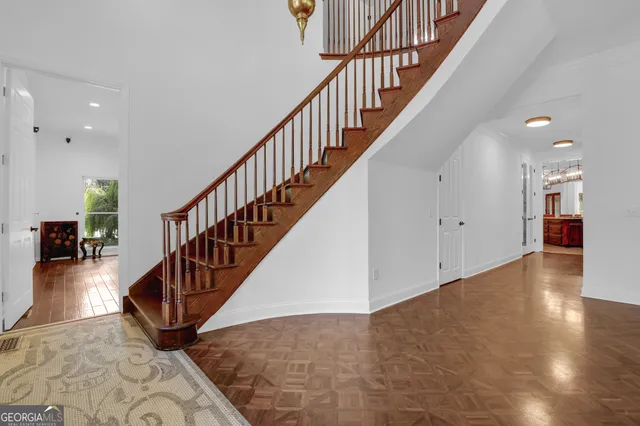an aerial view of residential houses with outdoor space and trees
