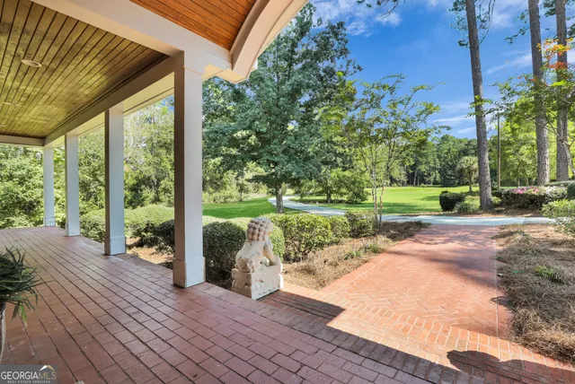 a view of an empty room with window and a fireplace