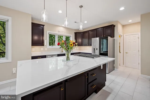 a large kitchen with kitchen island a sink stainless steel appliances and cabinets