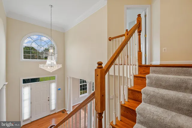 a view of entryway with wooden floor and stairs