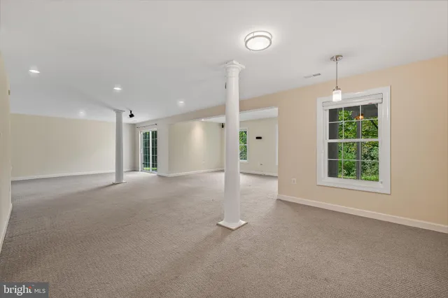 a view of a room with a windows and ceiling fan