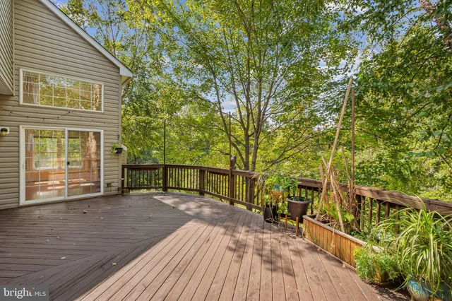 a view of a house with wooden floor next to a yard
