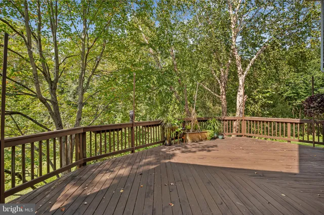 a view of balcony with wooden floor and fence