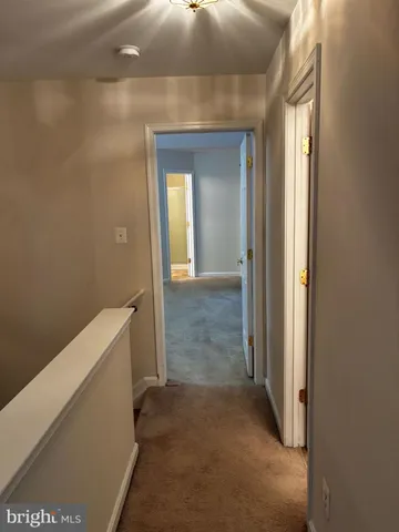 a view of hallway with bathroom