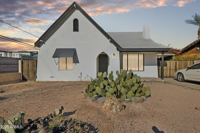 a picture of a room with furniture and a book shelf