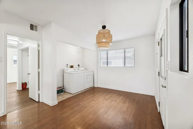 a view of a room with wooden floor and white walls