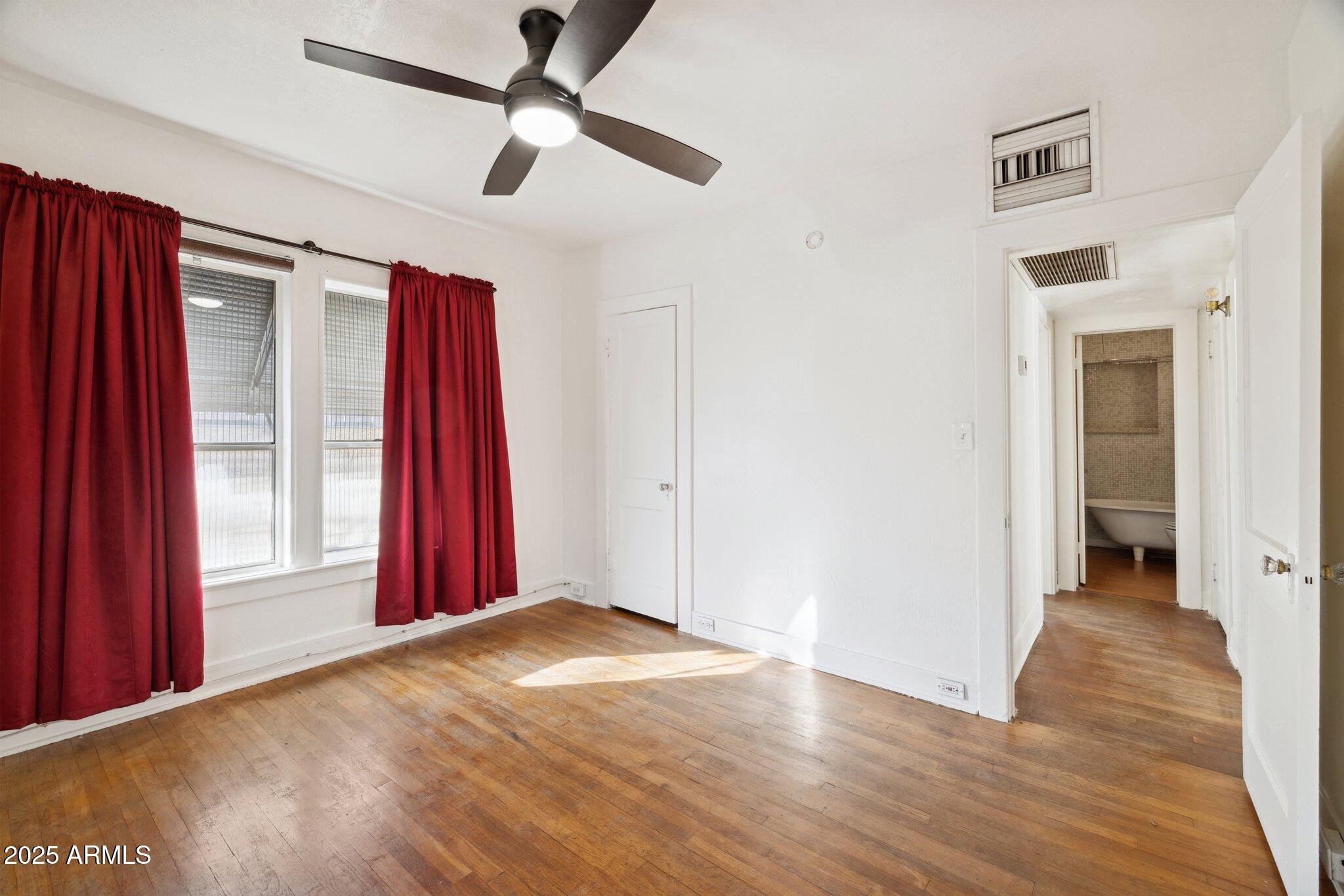 1614 East Roma Avenue Phoenix, AZ 85016 - Photo 21 of 44 a view of empty room with wooden floor and fan