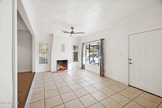 a living room with furniture a fireplace and a chandelier