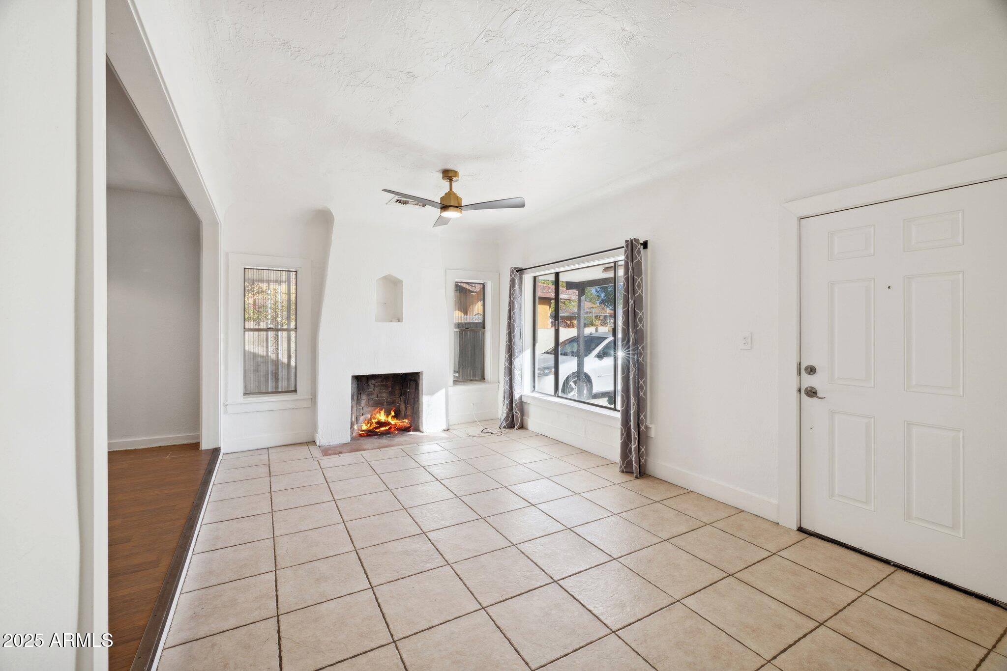 1614 East Roma Avenue Phoenix, AZ 85016 - Photo 6 of 44 a view of a livingroom with a fireplace and window