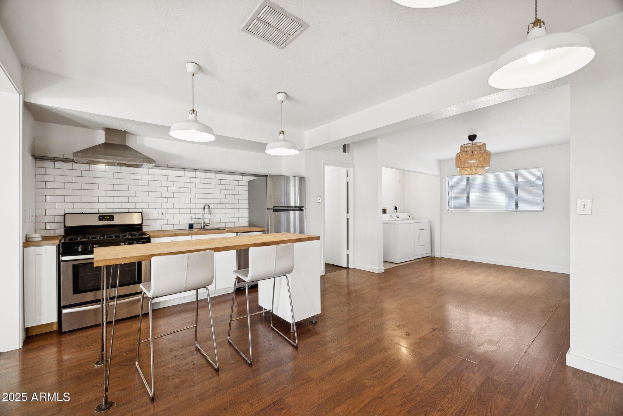1614 East Roma Avenue Phoenix, AZ 85016 - Photo 8 of 44 a view of a kitchen with a sink stove and wooden floor