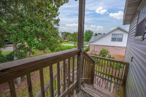 a view of a balcony with wooden floor