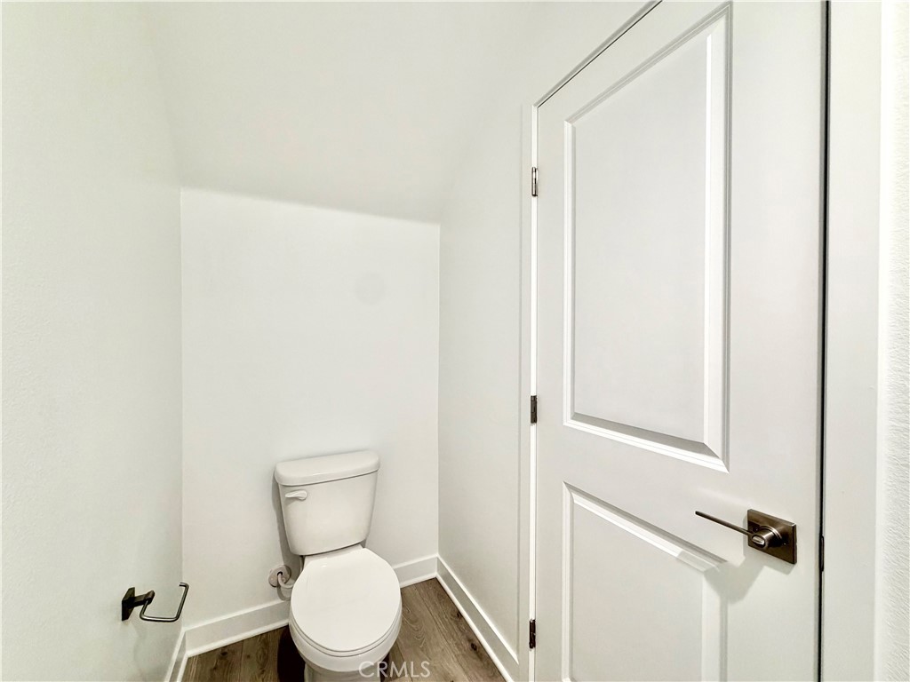 26893 Rubicon Road Menifee, CA 92586 - Photo 12 of 32 a white toilet sitting next to a white cabinet