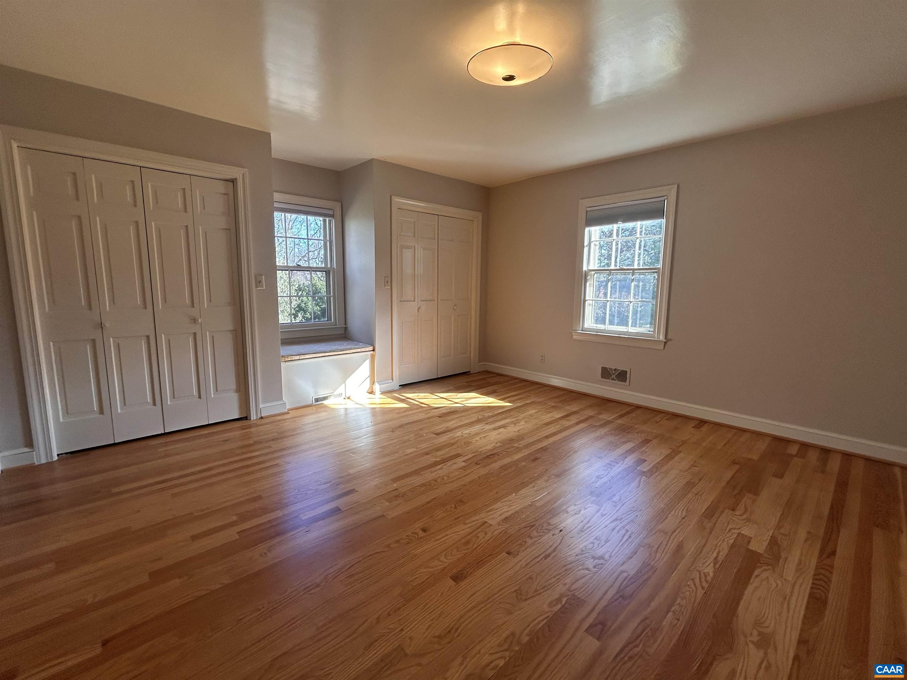 214 Montvue Drive Charlottesville, VA 22901 - Photo 13 of 30 an empty room with wooden floor and windows